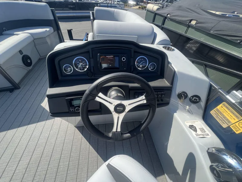 Slide: The Image of 2024 Bentley Pontoons Legacy 200 Cruise dashboard with steering wheel and gauges. - 9