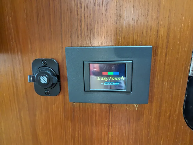 Slide: The Image of EasyTouch control panel on 2000 Tiara Yachts 3500 Express interior wood panel. - 13