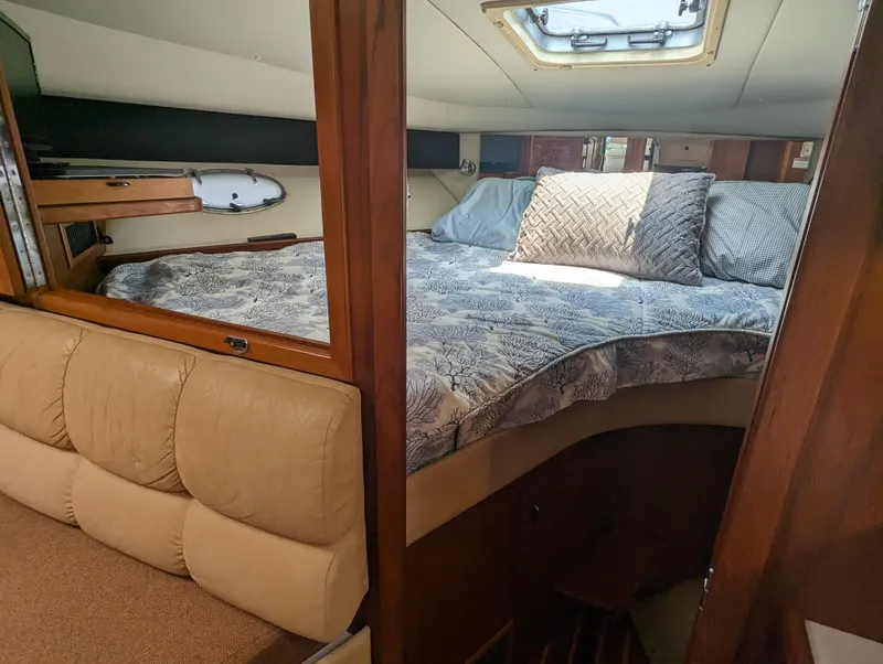 Slide: The Image of Cozy cabin interior of 2000 Tiara Yachts 3500 Express with bed and skylight. - 14