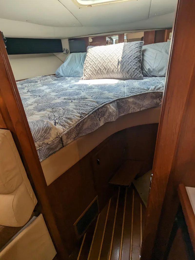Slide: The Image of 2000 Tiara Yachts 3500 Express cabin with cozy bed and wooden interior. - 15