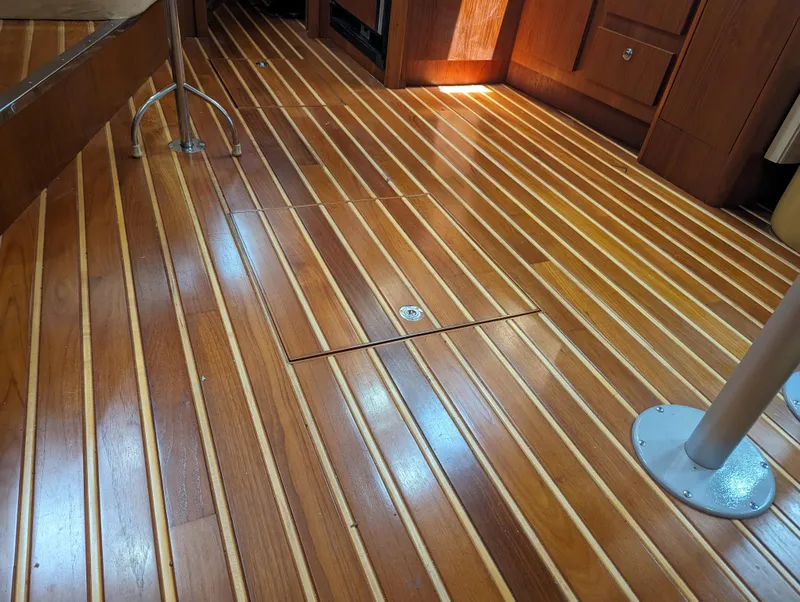 Slide: The Image of Teak wood flooring inside a 2000 Tiara Yachts 3500 Express, showcasing elegant craftsmanship. - 20