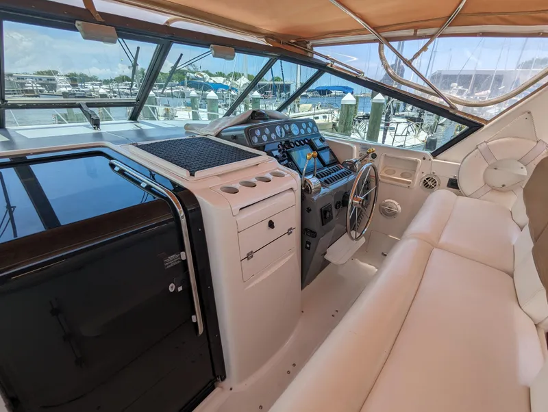 Slide: The Image of 2000 Tiara Yachts 3500 Express helm with leather seating and modern controls. - 22