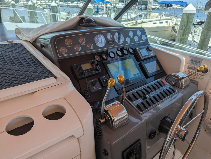 Slide: The Image of Control panel of a 2000 Tiara Yachts 3500 Express, featuring navigation and throttle controls. - 23
