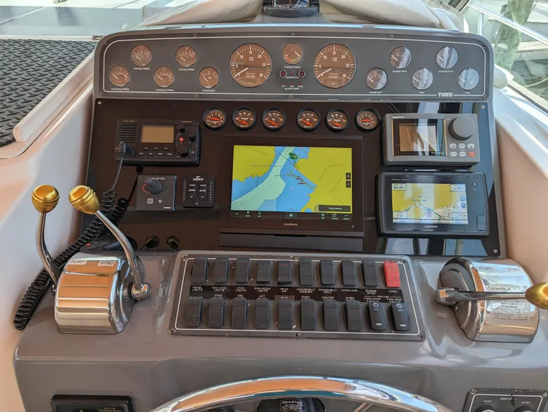 Slide: The Image of Control panel of a 2000 Tiara Yachts 3500 Express with navigation and throttle controls. - 24