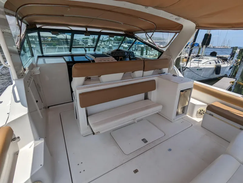 Slide: The Image of 2000 Tiara Yachts 3500 Express interior with seating and helm, docked at marina. - 27