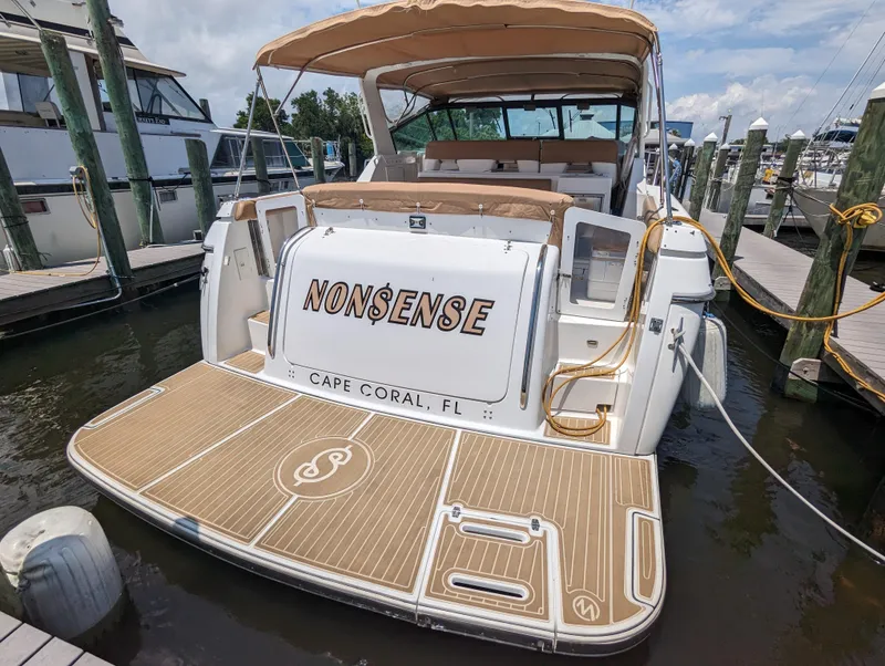 Slide: The Image of 2000 Tiara Yachts 3500 Express docked, named "Nonsense," in Cape Coral, FL. - 30