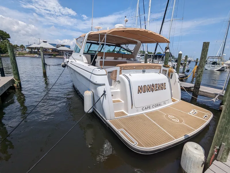Slide: The Image of 2000 Tiara Yachts 3500 Express docked, rear view with "Nonsense" name visible. - 32