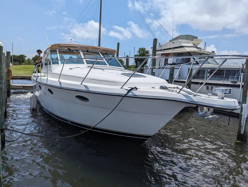 Slide: The Image of 2000 Tiara Yachts 3500 Express docked, featuring sleek white design and spacious deck. - 36