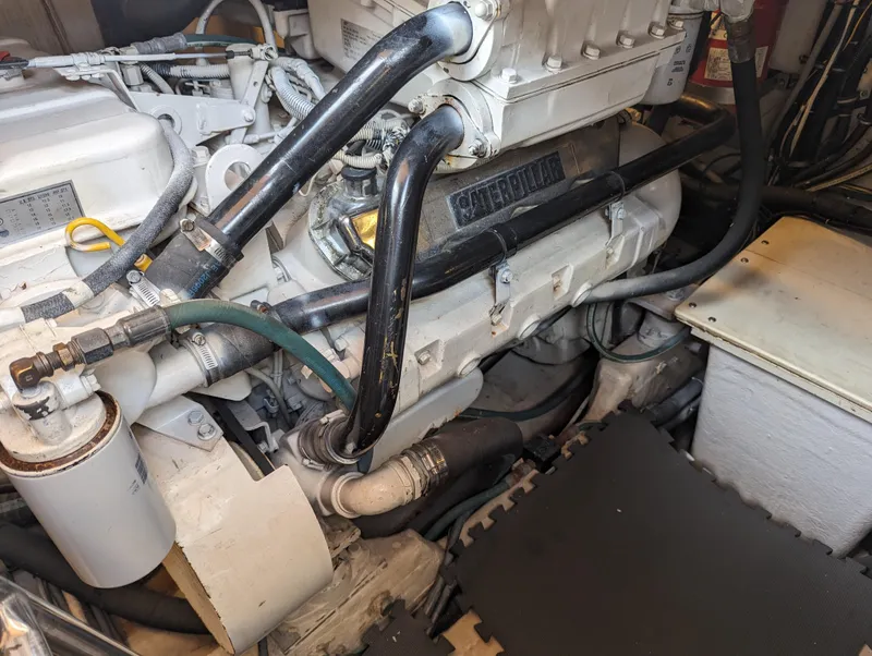 Slide: The Image of Engine compartment of a 2000 Tiara Yachts 3500 Express, showcasing mechanical components and hoses. - 39