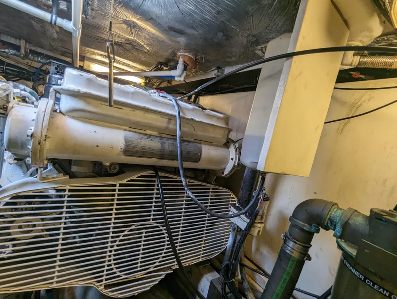 Slide: The Image of Engine room of a 2000 Tiara Yachts 3500 Express, showcasing mechanical components and piping. - 41