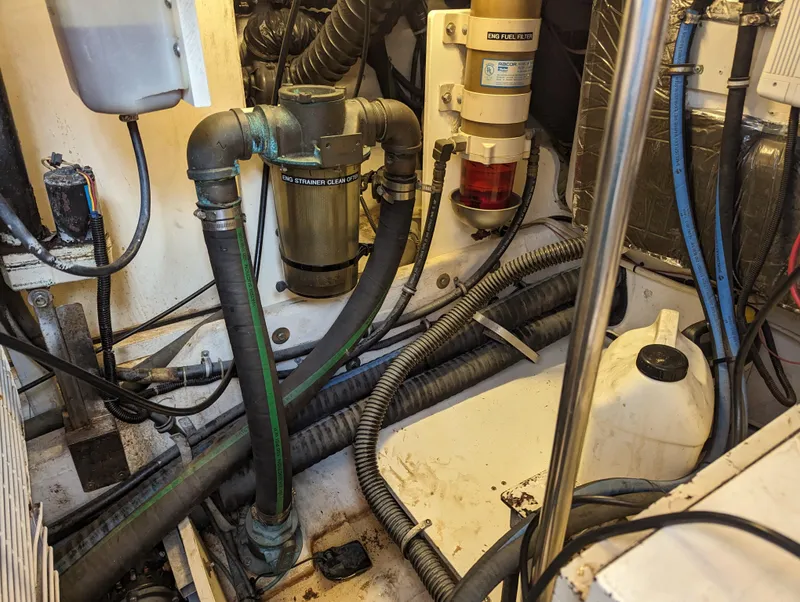 Slide: The Image of Engine room of a 2000 Tiara Yachts 3500 Express, showing hoses and mechanical components. - 42