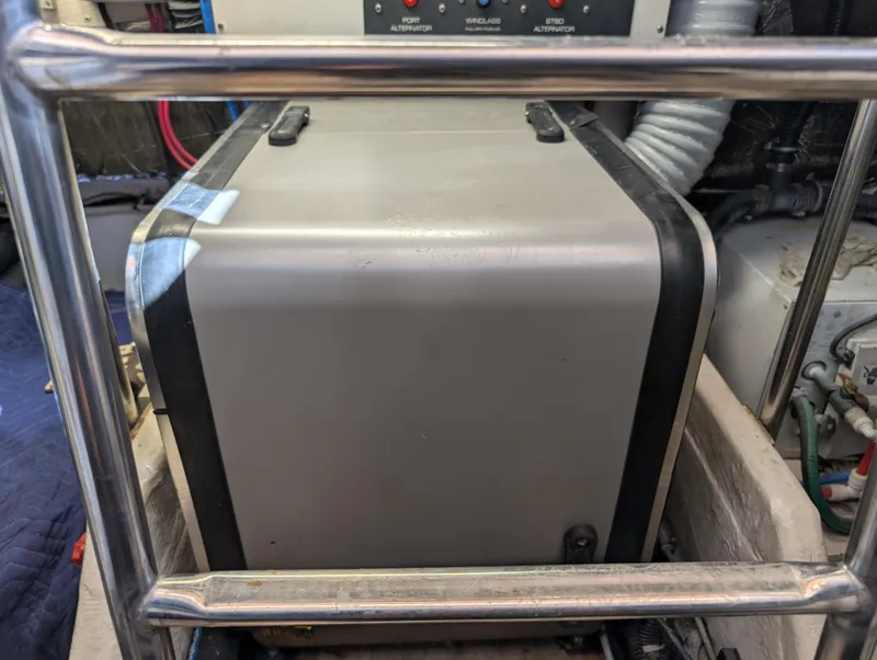 Slide: The Image of Engine compartment of a 2000 Tiara Yachts 3500 Express, featuring a generator unit. - 44