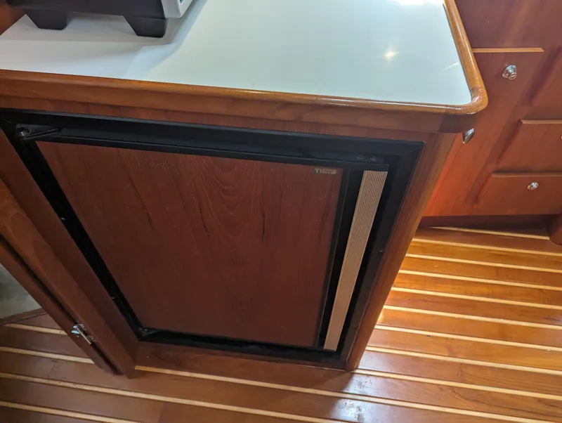Slide: The Image of Wooden cabinet with mini fridge in 2000 Tiara Yachts 3500 Express interior. - 9