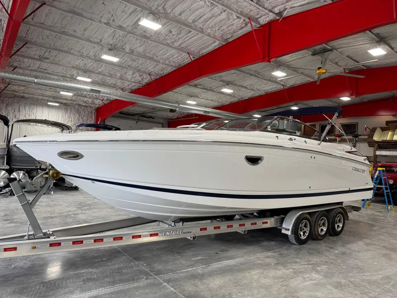 The Image of 2009 Cobalt 302 BR boat on trailer in spacious indoor storage facility. - 1