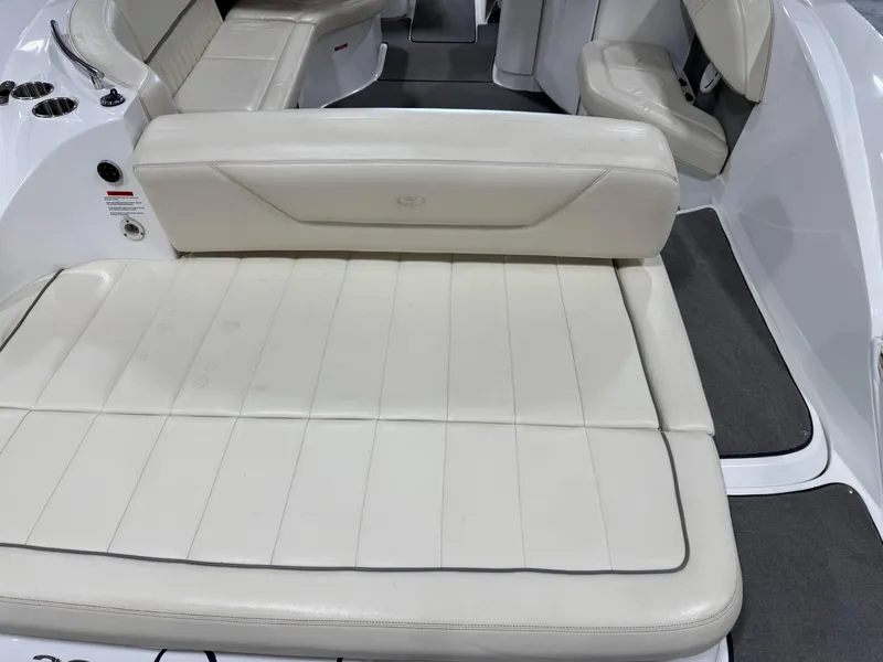 Slide: The Image of 2009 Cobalt 302 BR boat interior with beige leather seating and gray flooring. - 11