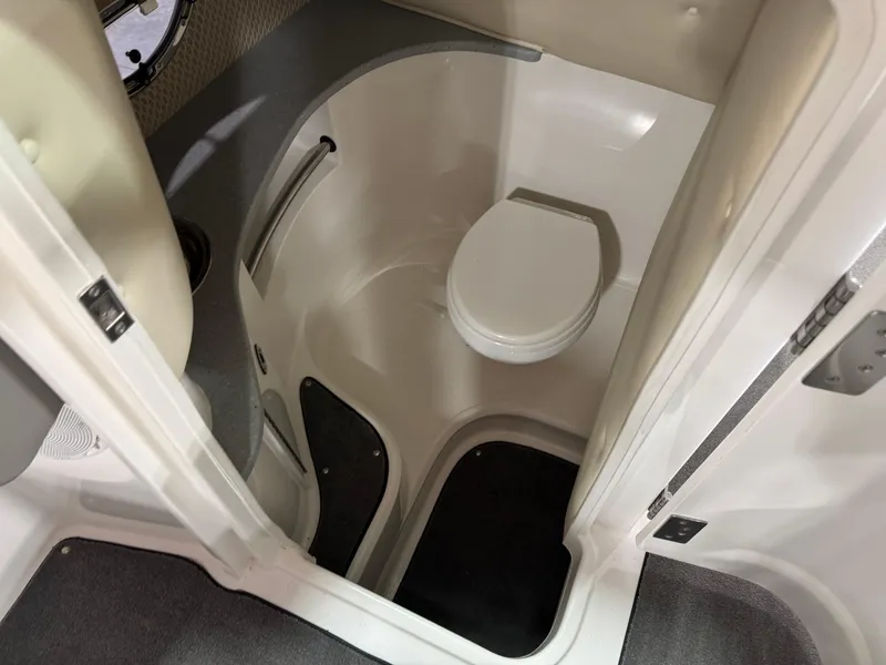 Slide: The Image of 2009 Cobalt 302 BR boat interior with compact marine toilet. - 12
