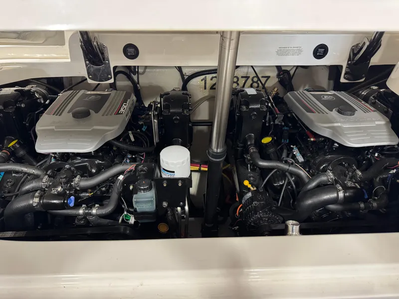 Slide: The Image of Twin engines of a 2009 Cobalt 302 BR boat, showcasing detailed mechanical components. - 13