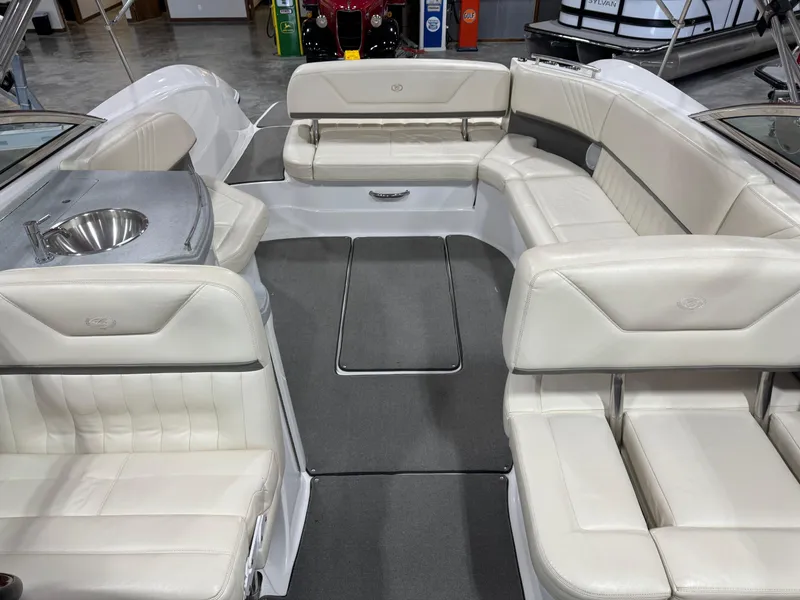 Slide: The Image of 2009 Cobalt 302 BR boat interior with white leather seating and built-in sink. - 5