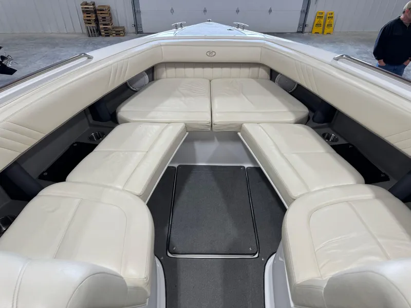 Slide: The Image of 2009 Cobalt 302 BR boat interior with white leather seating in a spacious layout. - 6
