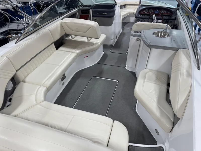 Slide: The Image of 2009 Cobalt 302 BR boat interior with white leather seating and modern dashboard. - 9