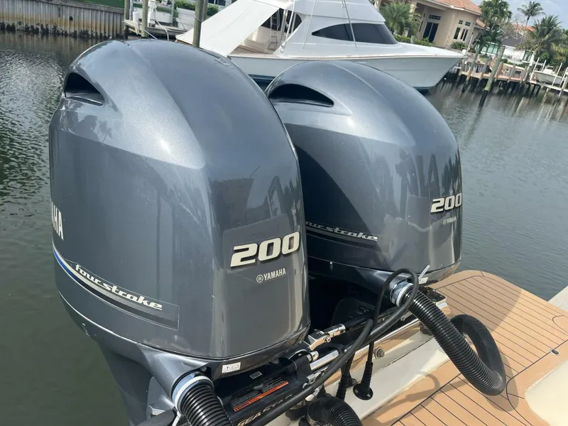 Slide: The Image of Twin Yamaha 200 outboard engines on a 2020 Scout 277LXF boat docked by the water. - 18