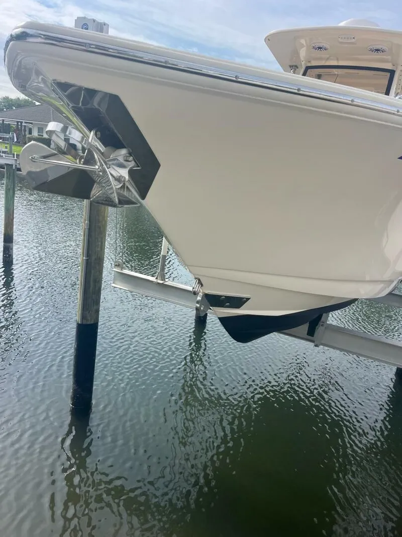 Slide: The Image of 2020 Scout 277LXF boat docked on water, showcasing sleek design and modern features. - 22