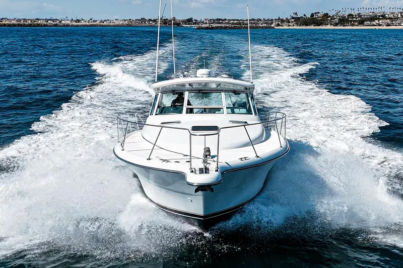 Slide: The Image of 2001 Tiara Yachts 3500 Open cruising on open water, creating a dynamic wake. - 11