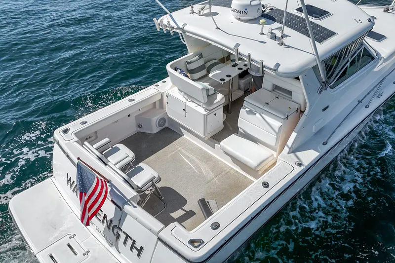 Slide: The Image of 2001 Tiara Yachts 3500 Open cruising on water, rear view with American flag. - 14