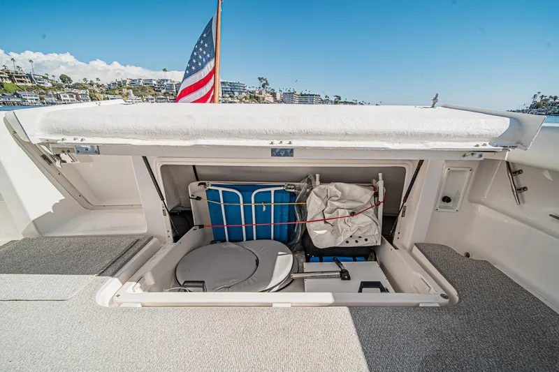 Slide: The Image of 2001 Tiara Yachts 3500 Open storage compartment with American flag in background. - 16