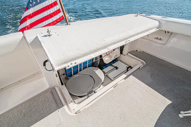Slide: The Image of 2001 Tiara Yachts 3500 Open storage compartment with American flag, on calm water. - 17