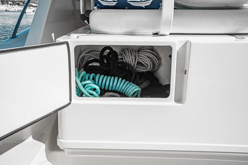 Slide: The Image of Storage compartment on a 2001 Tiara Yachts 3500 Open, containing coiled ropes. - 18