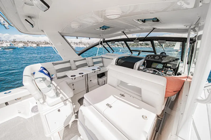 Slide: The Image of Interior of 2001 Tiara Yachts 3500 Open, featuring luxurious seating and helm, overlooking the ocean. - 22