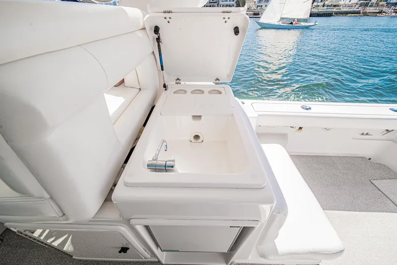 Slide: The Image of 2001 Tiara Yachts 3500 Open interior with sink, overlooking water and sailboat. - 25