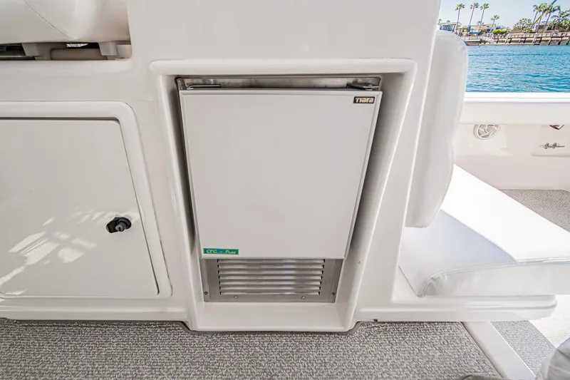 Slide: The Image of 2001 Tiara Yachts 3500 Open interior with built-in refrigerator, dockside view. - 26