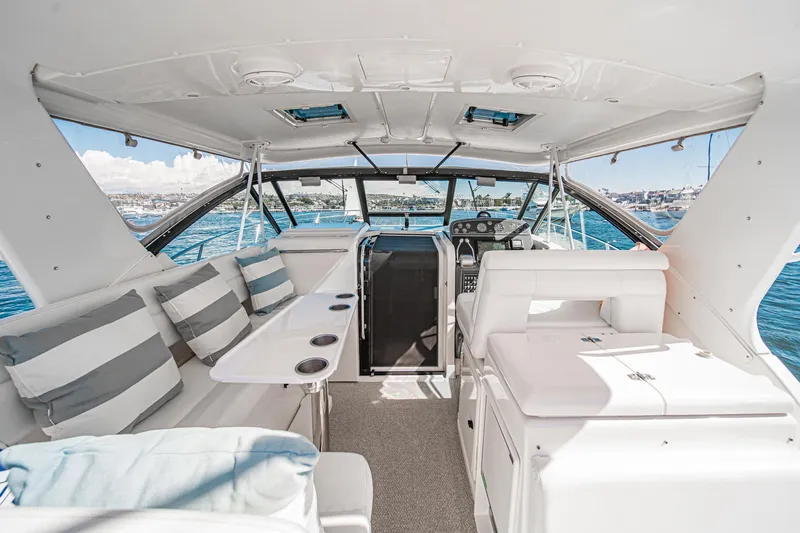 Slide: The Image of 2001 Tiara Yachts 3500 Open interior with striped seating and ocean view. - 27