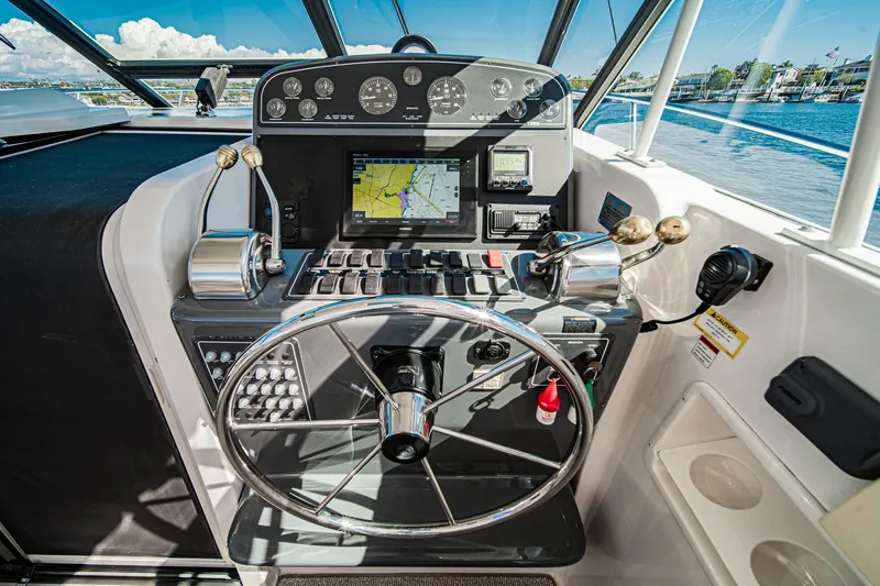 Slide: The Image of 2001 Tiara Yachts 3500 Open helm with navigation controls and steering wheel. - 30