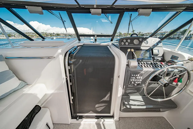Slide: The Image of 2001 Tiara Yachts 3500 Open cockpit with steering wheel and navigation controls. - 31