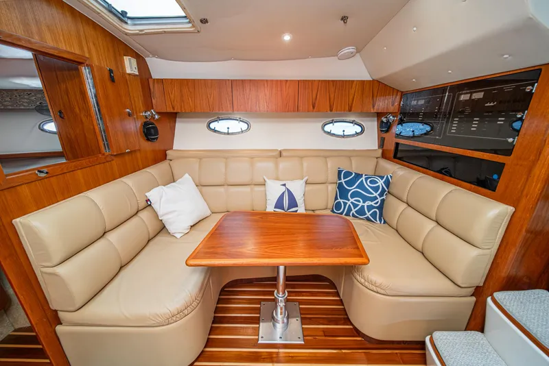 Slide: The Image of Luxurious 2001 Tiara Yachts 3500 Open interior with plush seating and elegant wood finishes. - 35