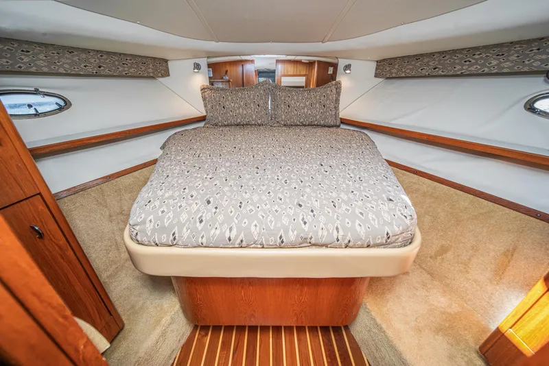 Slide: The Image of Luxurious cabin interior of 2001 Tiara Yachts 3500 Open with cozy bed and wood accents. - 42