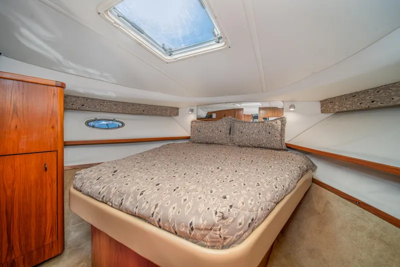 Slide: The Image of 2001 Tiara Yachts 3500 Open cabin interior with bed and wooden cabinetry. - 44