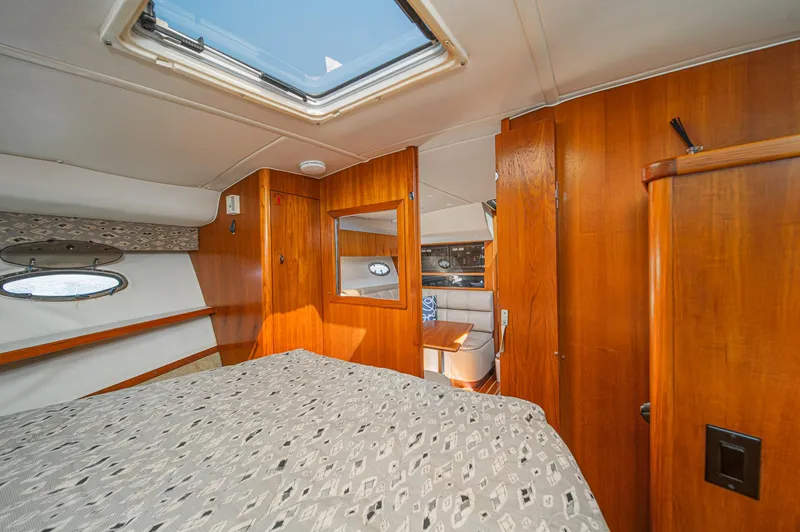 Slide: The Image of Interior of 2001 Tiara Yachts 3500 Open, featuring wood paneling and a skylight. - 45