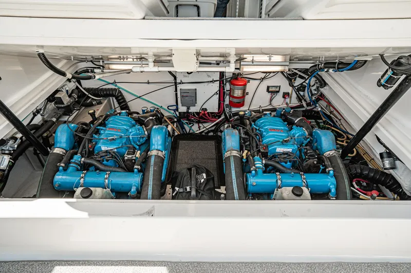 Slide: The Image of Engine compartment of 2001 Tiara Yachts 3500 Open, featuring dual blue engines and wiring. - 48