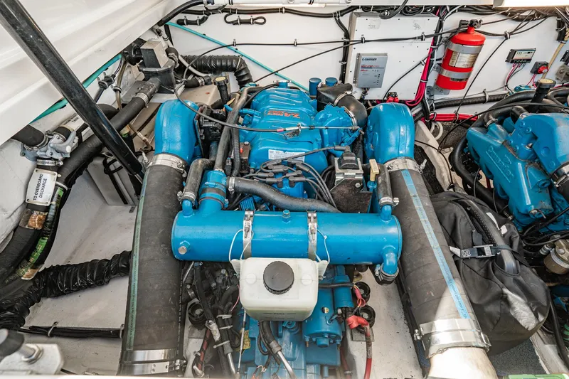 Slide: The Image of Engine compartment of a 2001 Tiara Yachts 3500 Open, featuring a blue marine engine. - 49