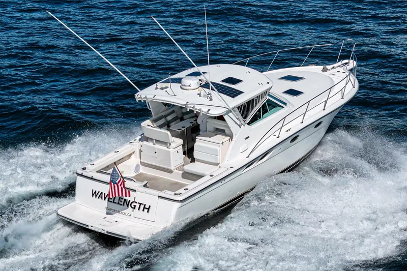 Slide: The Image of 2001 Tiara Yachts 3500 Open cruising on the ocean, rear view with American flag. - 5