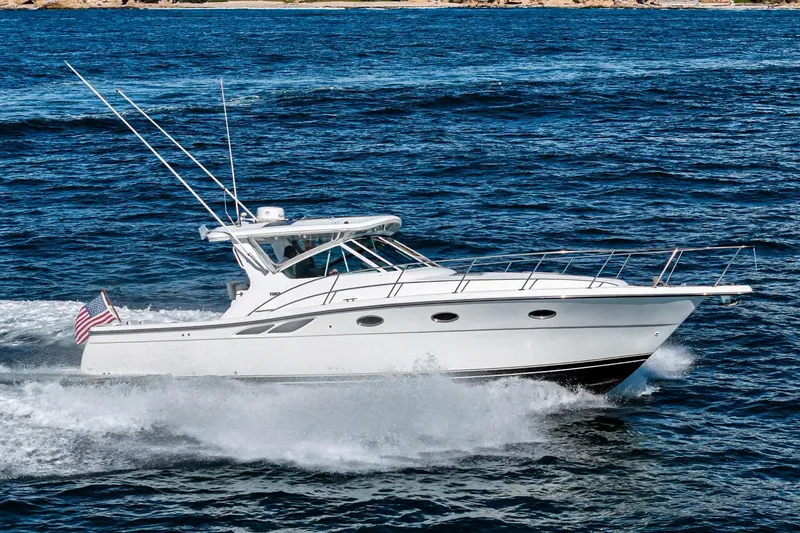 Slide: The Image of 2001 Tiara Yachts 3500 Open cruising on the ocean with American flag. - 8