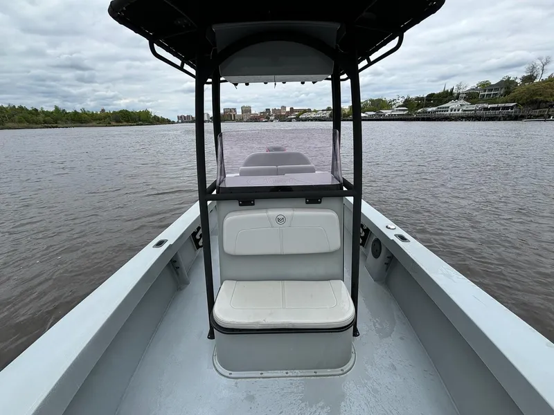 Slide: The Image of 2022 May-Craft 23 Cape Classic boat on calm water, featuring a center console. - 10