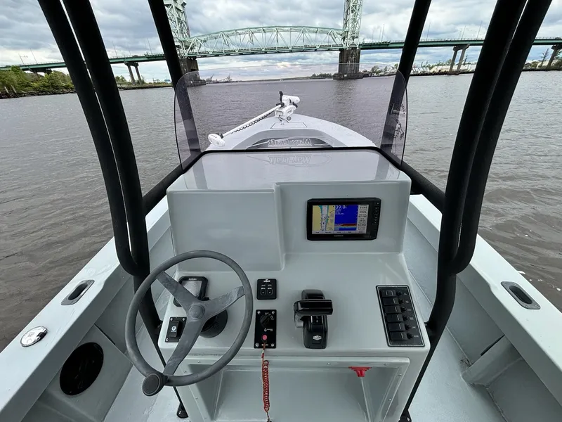 Slide: The Image of 2022 May-Craft 23 Cape Classic boat interior with steering wheel and navigation system. - 11
