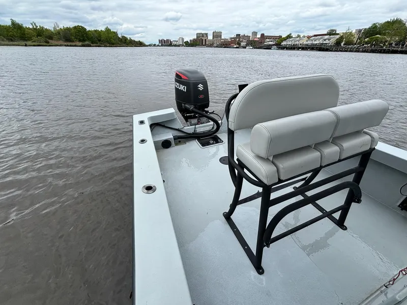 Slide: The Image of 2022 May-Craft 23 Cape Classic boat on calm river with Suzuki outboard motor. - 12