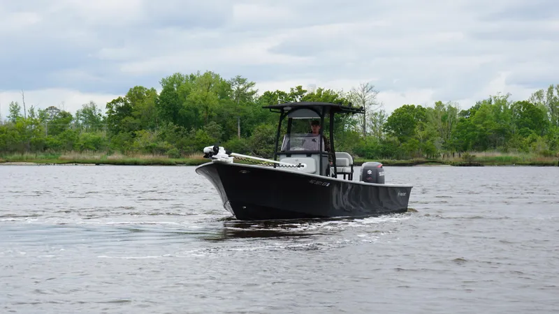 Slide: The Image of 2022 May-Craft 23 Cape Classic boat cruising on a calm river. - 5