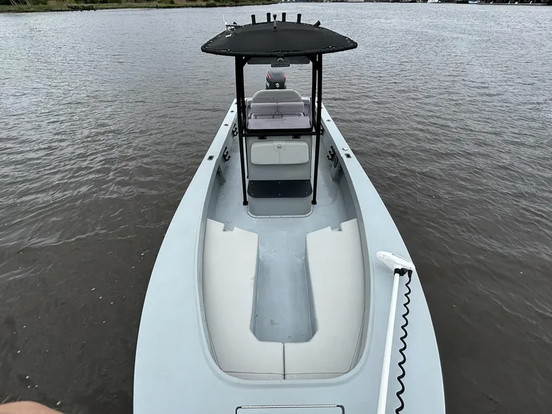 Slide: The Image of 2022 May-Craft 23 Cape Classic boat on calm water, featuring a sleek design and spacious deck. - 8